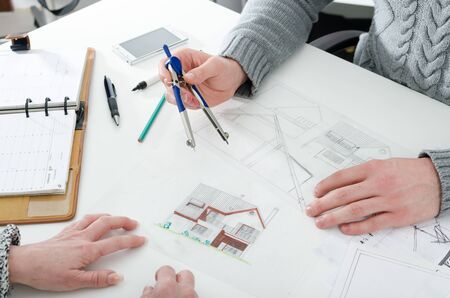 Architect showing house plans to his clientの写真素材