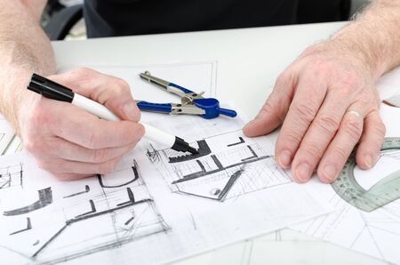 Architect working on plans of  new houseの写真素材