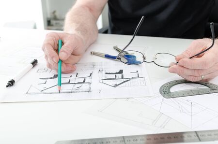 Architect working on plans of  new house