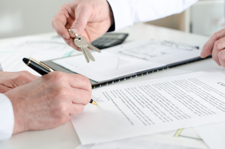 Client signing a real estate contract in real estate agencyの写真素材