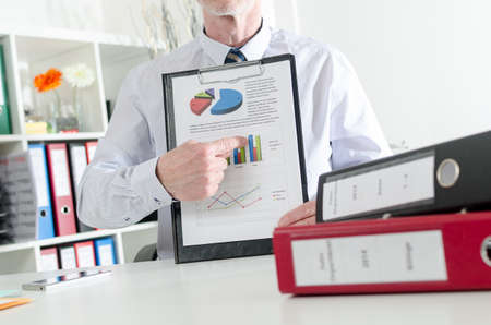 Businessman showing financial results, at the office