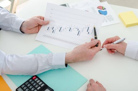 Business team working on stock charts, at the office