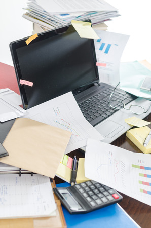 View of a untidy and cluttered deskの写真素材