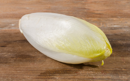 Fresh chicory on wooden background
