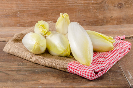 Chicories on wooden backgroundの写真素材