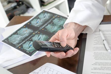 Doctor using a phone at his deskの写真素材