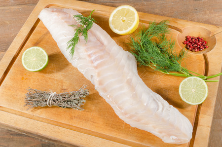 Cod fillet on wooden board