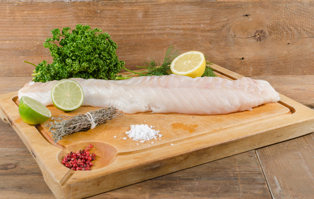 Cod fillet on wooden board