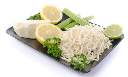 Tasty grated celery on a plate, isolated on whiteの写真素材