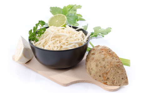 Bowl of tasty grated celery, isolated on whiteの写真素材