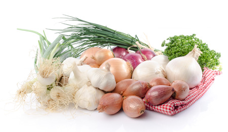 Composition with different types of onions, garlic and shallots, isolated on whiteの写真素材