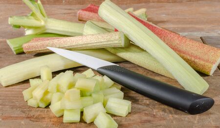 Fresh chopped rhubarb on wooden backgroundの写真素材