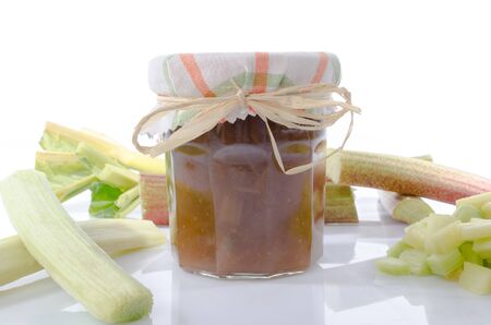 Rhubarb jam jar with fresh rhubarb, isolated on whiteの写真素材