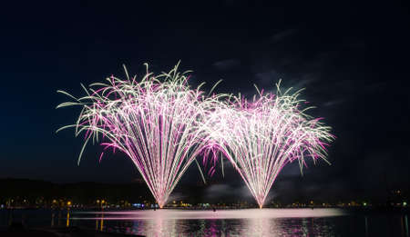 Beautiful fireworks show on a lakeの写真素材