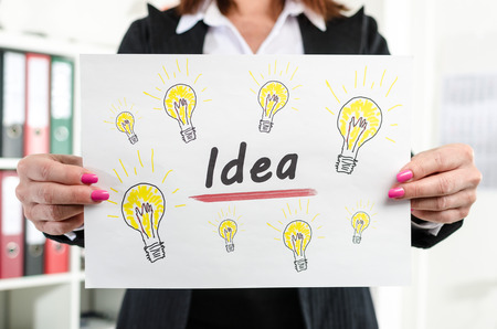 Businesswoman showing idea concept at officeの写真素材