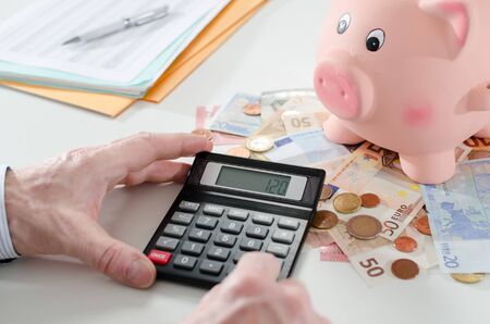 Man counting the amount of his savingsの写真素材