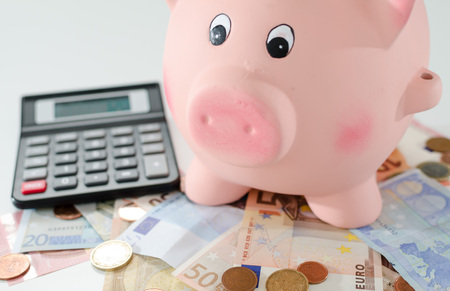 Piggy bank, money and calculatorの写真素材