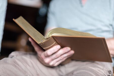 Man sitting at home reading the Bible