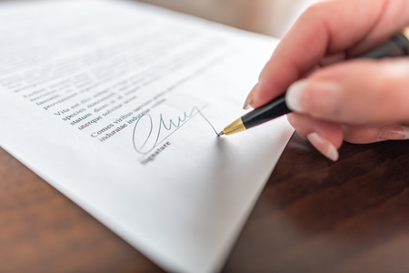 Woman hand signing a contract