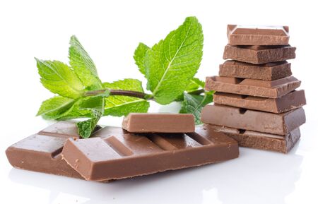 Chocolate squares with fresh mint, isolated on whiteの写真素材