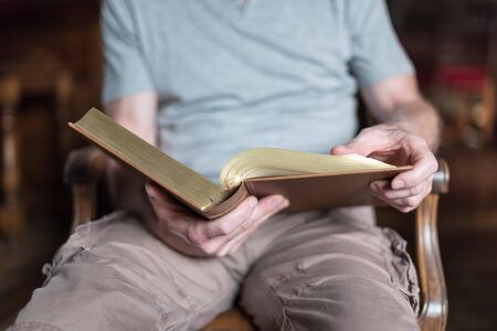 Man sitting at home reading the Bible