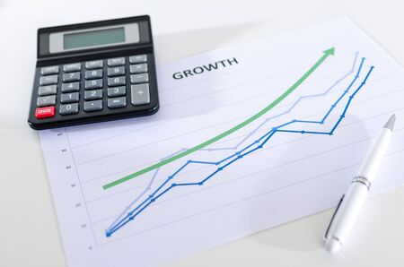 Financial graphs showing growth with calculator closeupの写真素材