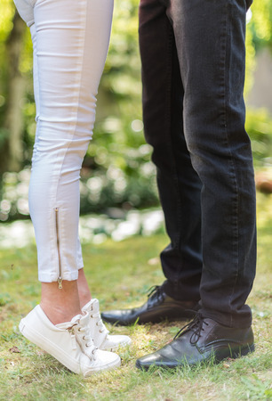 Legs of a couple hugging in parkの写真素材