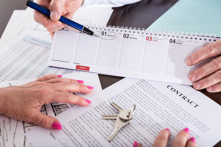 Real estate agent showing the effective date of lease on calendar (random english dummy text used)