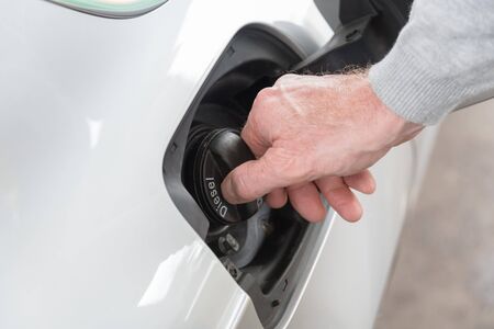 Hand opening the fuel tank capの写真素材