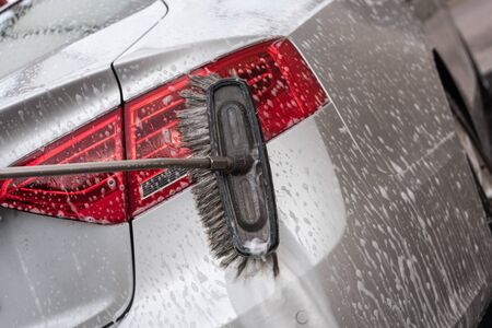 Car washing with a brushの写真素材