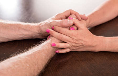 Woman and man holding hands with love