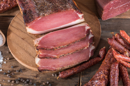 Smoked sausages and meats on wooden backgroundの写真素材