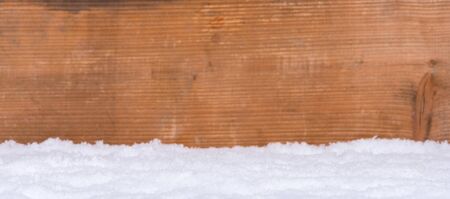 Snow on wooden background