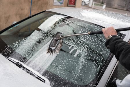 Car washing with a brushの写真素材