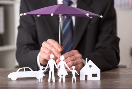 Concept of insurance with umbrella over a house, a car and a familyの写真素材