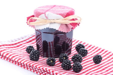 Blackberry jam with fresh blackberries on a dish towelの写真素材