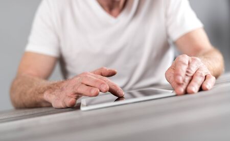 Man sitting using a tablet