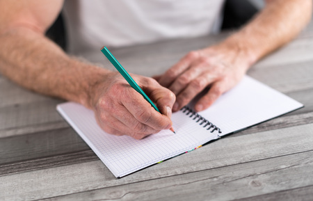 Man taking notes on a pocket book