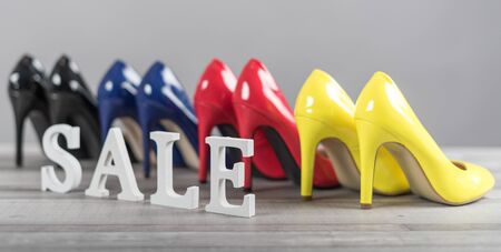 Sale sign with high heels shoes set on grey backgroundの写真素材