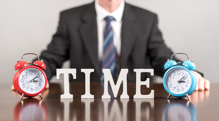 Time concept with alarm clocks and businessmanの写真素材
