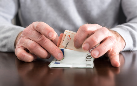 Hands counting euro banknotes