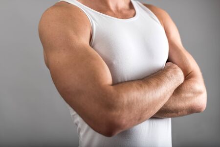 Athletic man with crossed armsの写真素材