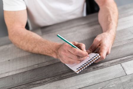 Man taking notes on a pocket bookの写真素材
