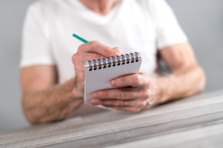 Man taking notes on a pocket book
