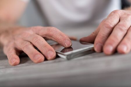 Finger touching a smartphone screenの写真素材