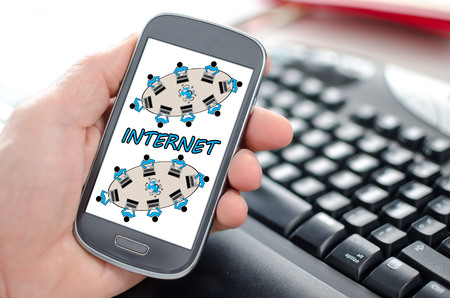 Hand holding a smartphone showing a internet conceptの写真素材