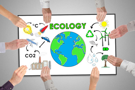 Ecology concept on a whiteboard held by handsの写真素材