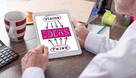 Ideas concept shown on a tablet held by a manの写真素材