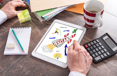 Man using a tablet showing a startup concept