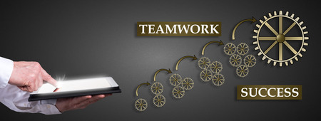 Man using a tablet with teamwork success conceptの写真素材